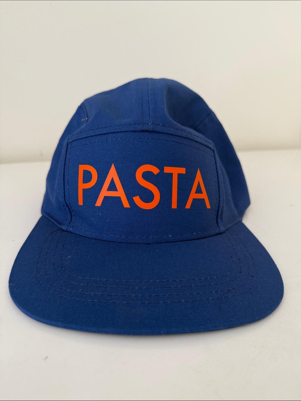 Blue Cap with PASTA in Orange PASTA on the front and RAMEN on the inside cap.